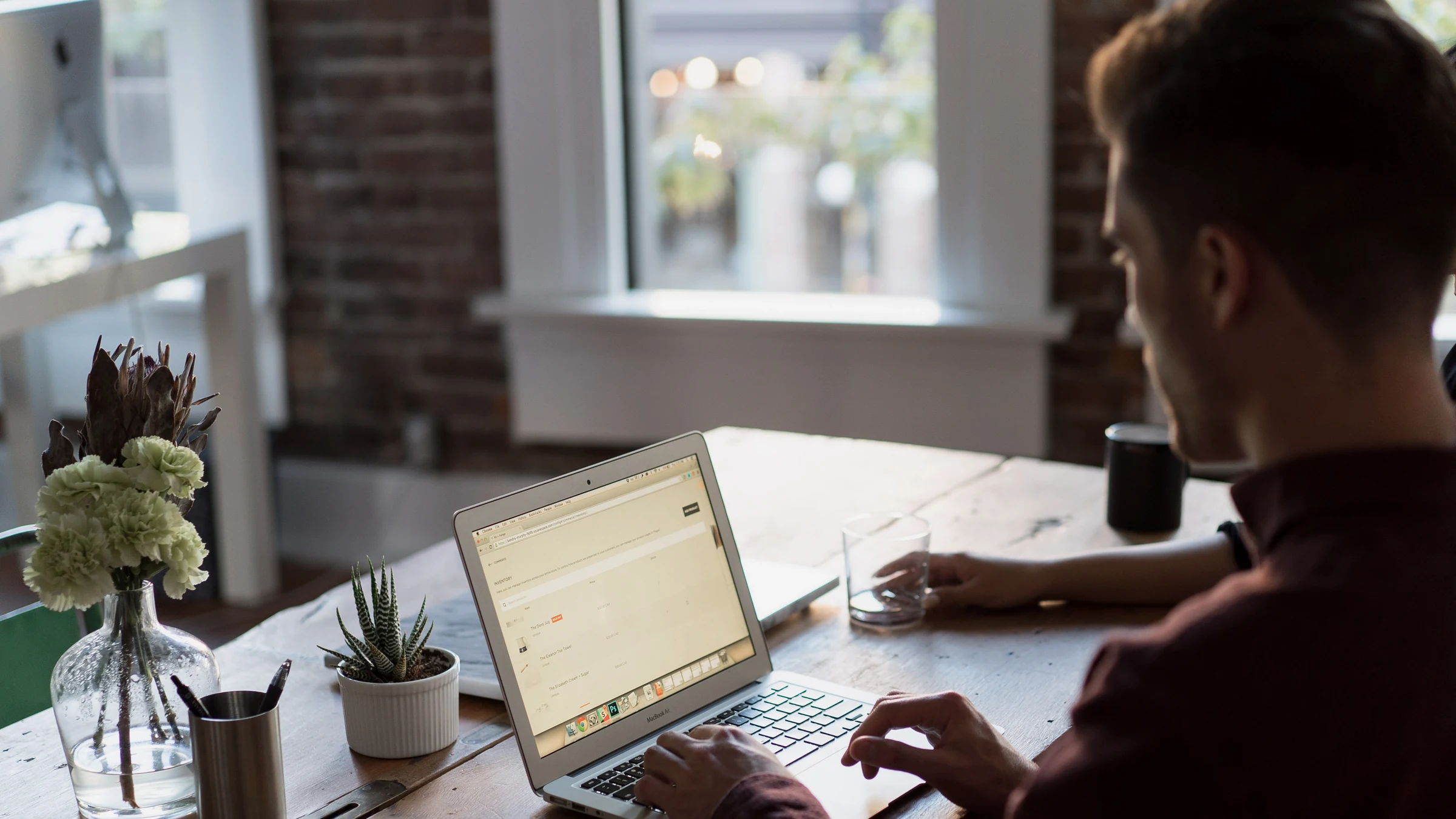 A person working through a laptop task in an office, used to represent the operating layer around an AI agent